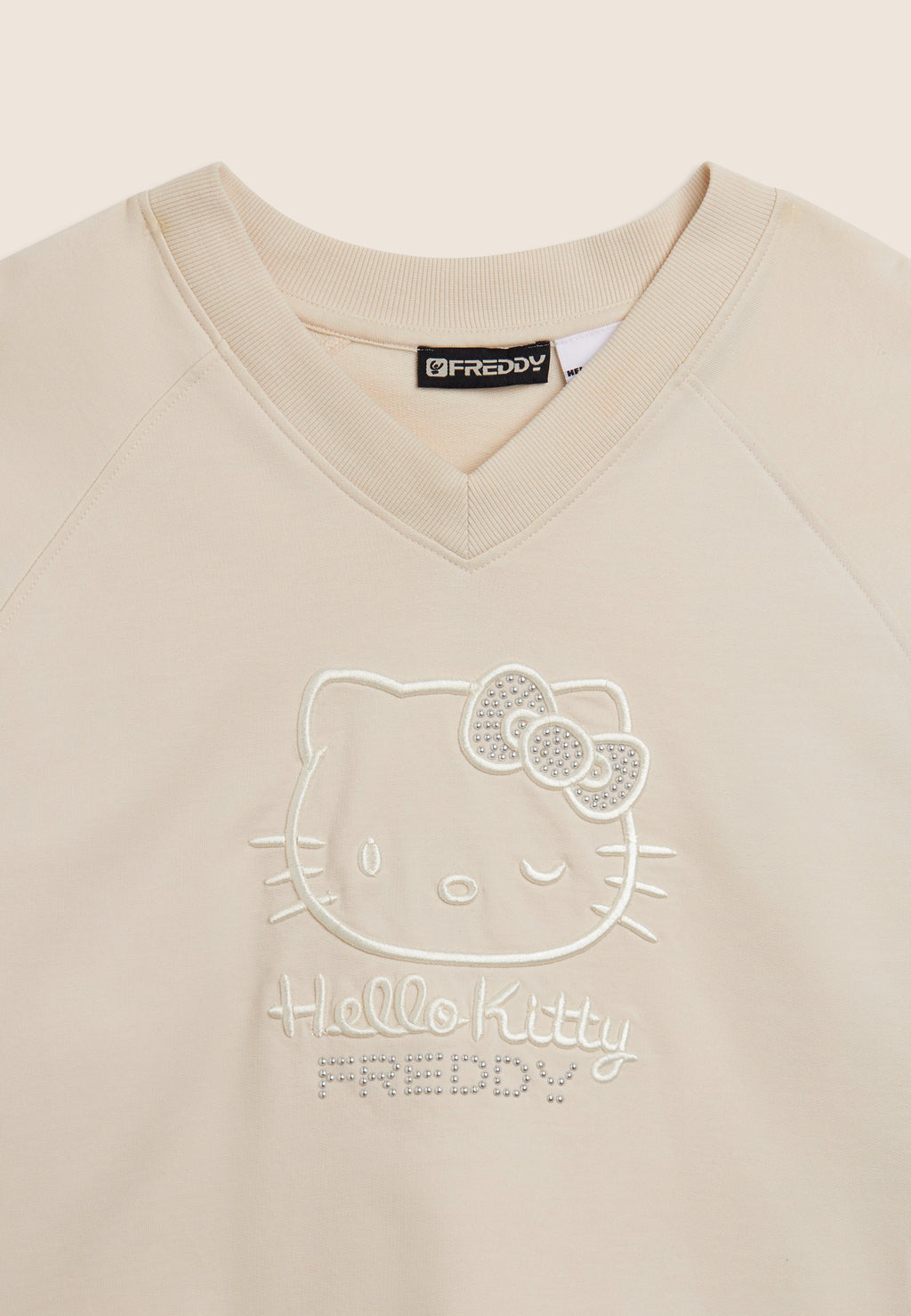 Zkrácená mikina s výstřihem do V a výšivkou Hello Kitty v béžové barvě